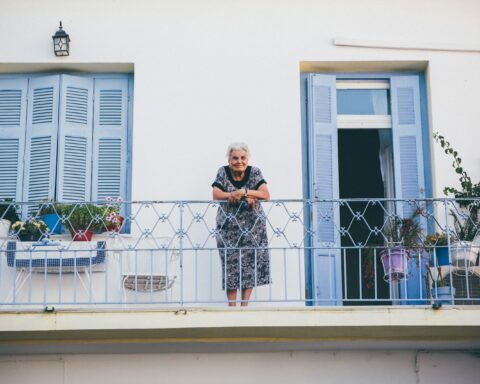 person standing on gray steel railings