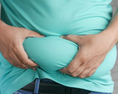 a man holding his stomach with his hands